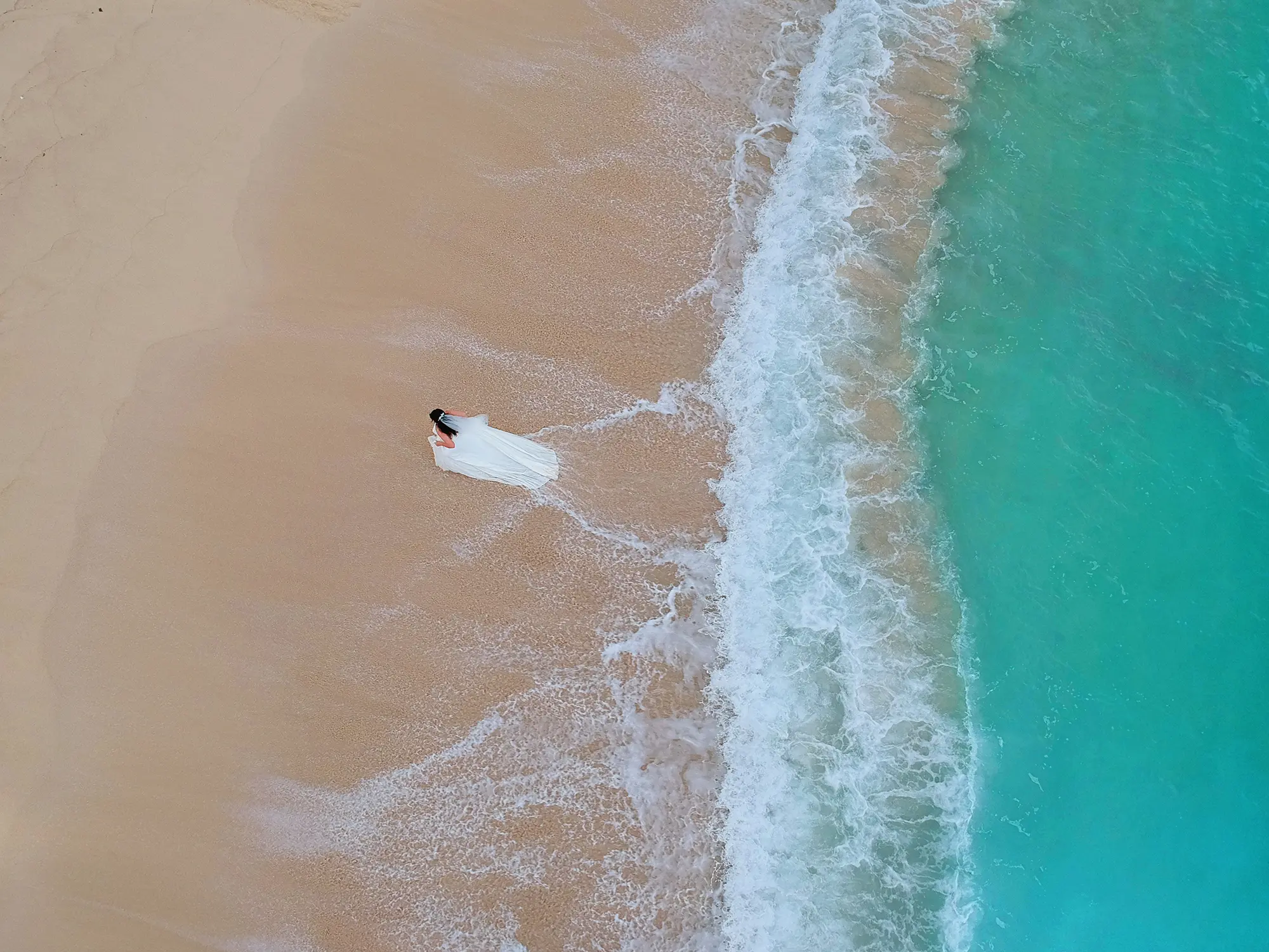 Wedding drone photography at Shangri-La Le Touessrok Mauritius, bride photographed from above on the beach
